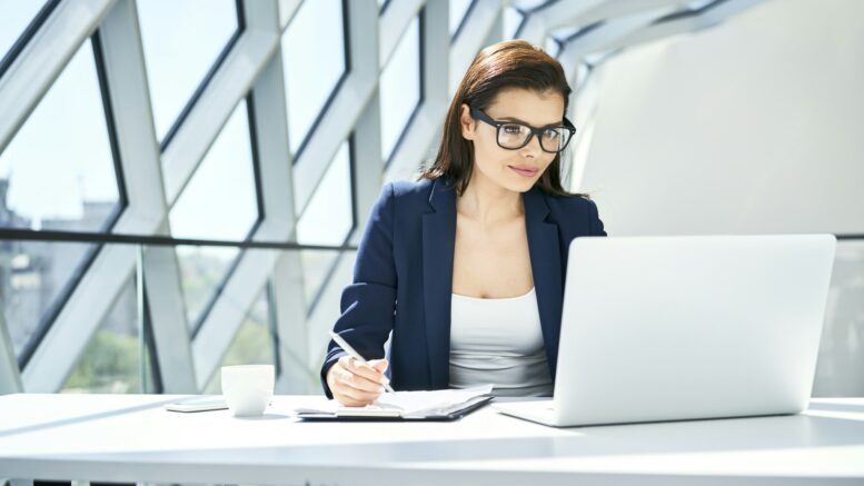 Businesswoman working at desk in modern office